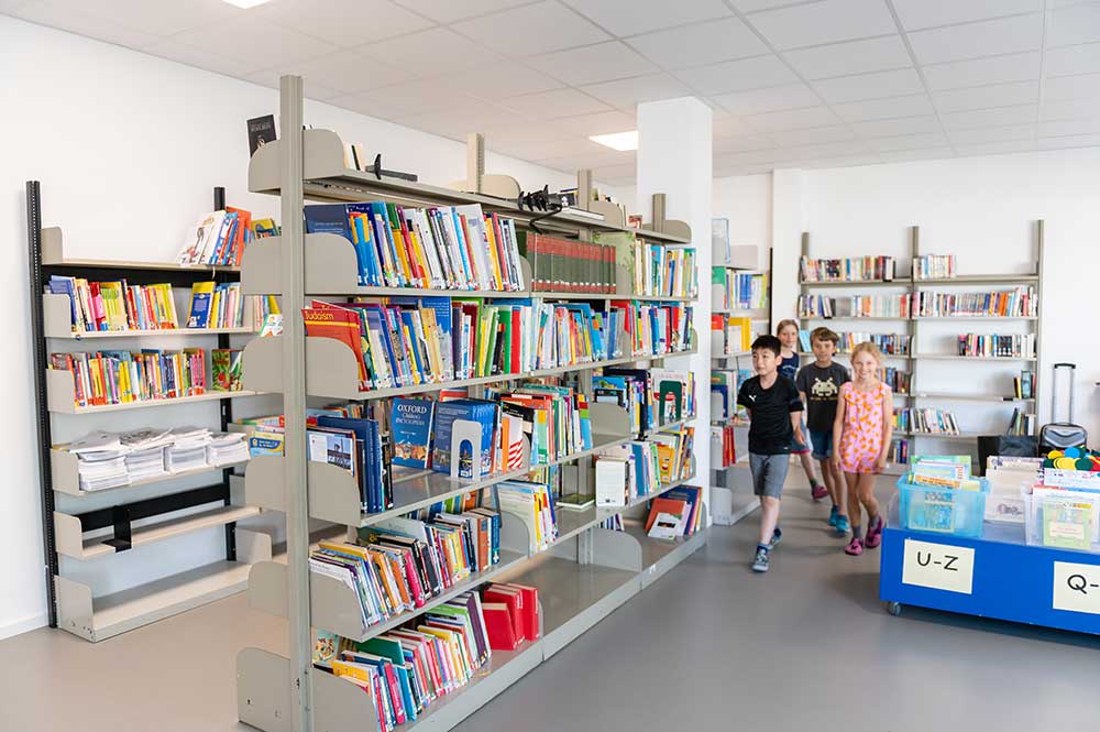 A view into the library with shelves full of books. 